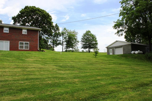 65 Iron Ridge Road Rocky Mount, VA 24151 - Photo 10 of 33 a front view of a house with a garden