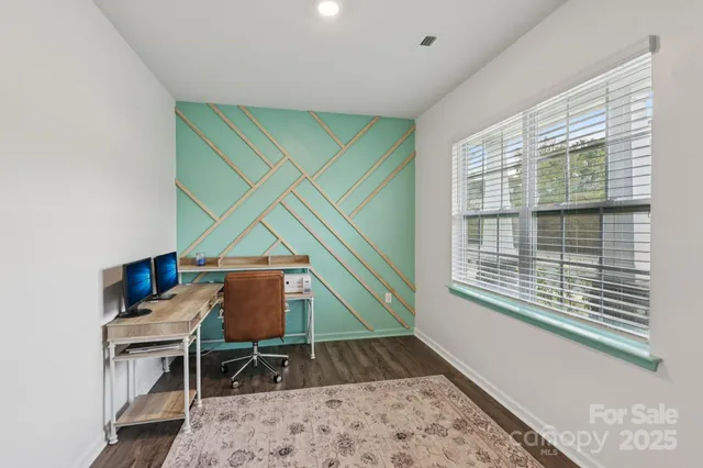 a workspace with furniture and a wooden floor