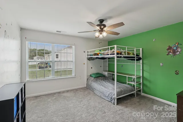 a living room with a ceiling fan and a window