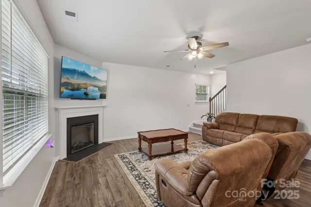 a living room with furniture a fireplace and a window