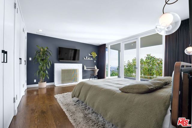 a bedroom with a large bed and a large window