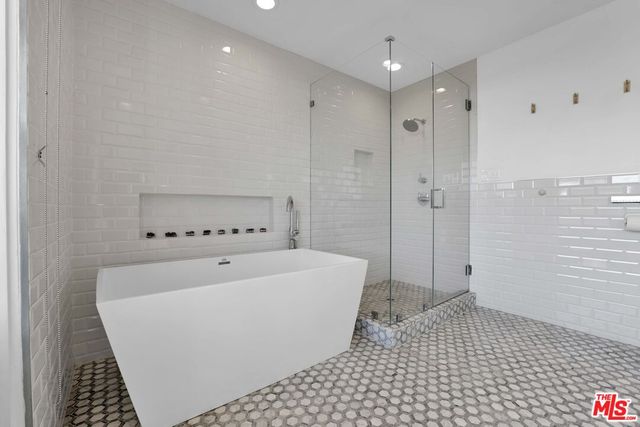 a bedroom with a bed window and glass door
