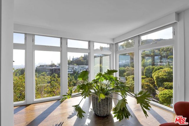 a living room with furniture and a floor to ceiling window