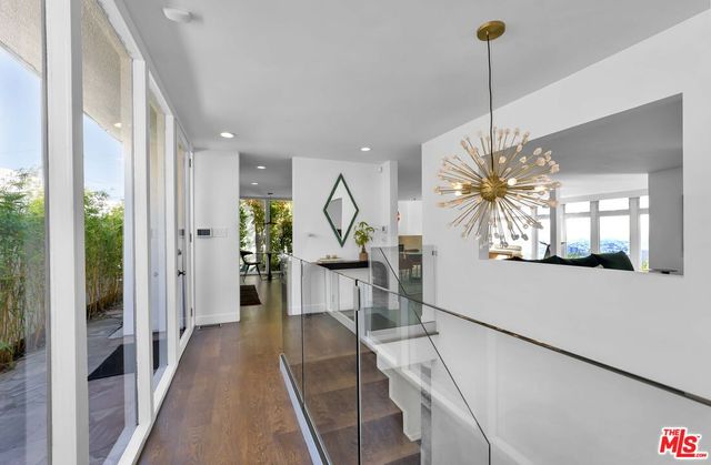 a living room with furniture a flat screen tv and a large window