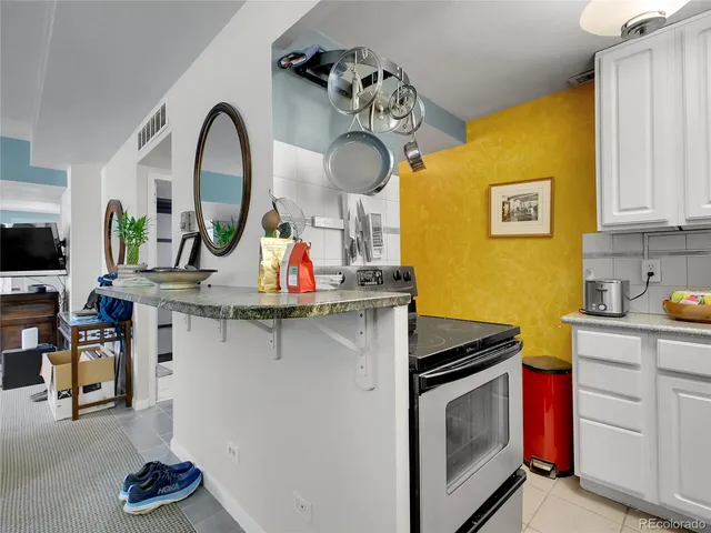 a kitchen with stainless steel appliances granite countertop a stove and cabinets