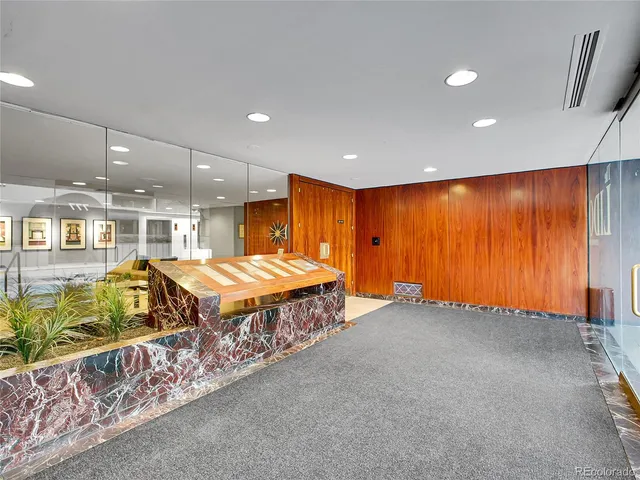 a spacious bedroom with a bed and a chandelier