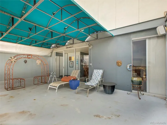 a view of a patio with table and chairs under an umbrella