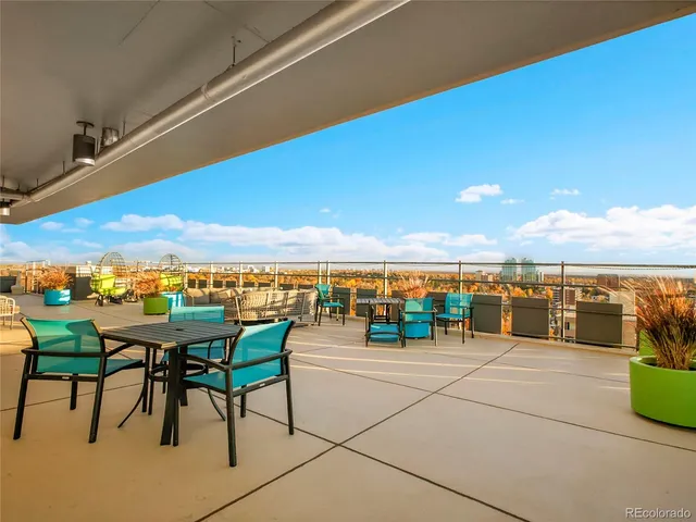 a view of a terrace with furniture and city view
