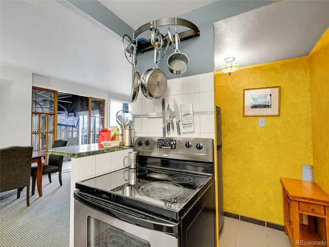 a stove top oven sitting inside of a kitchen