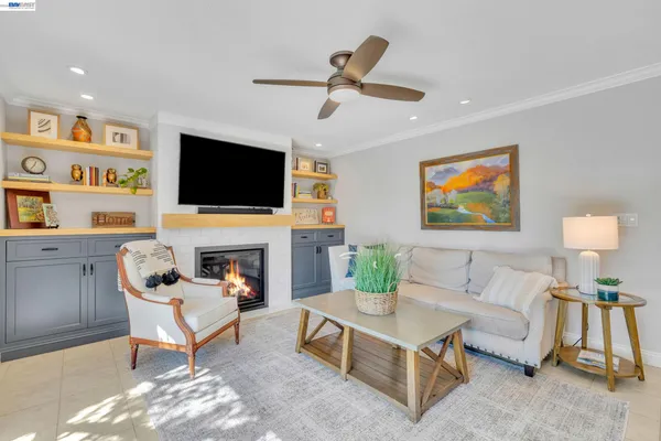 a living room with furniture a fireplace and a flat screen tv
