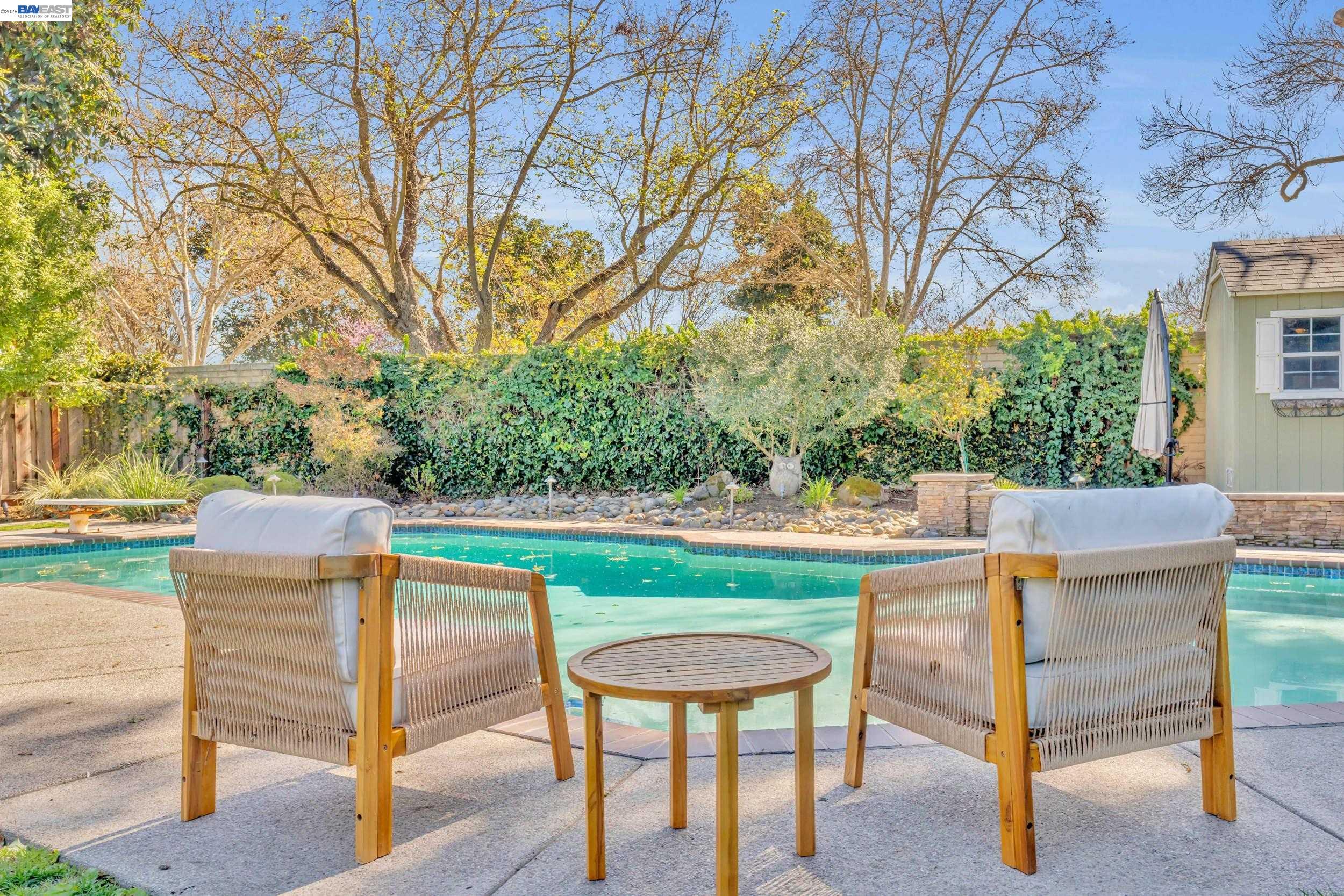 2070 Raven Road Pleasanton, CA 94566 - Photo 23 of 34 a view of a backyard with table and chairs potted plants and large tree