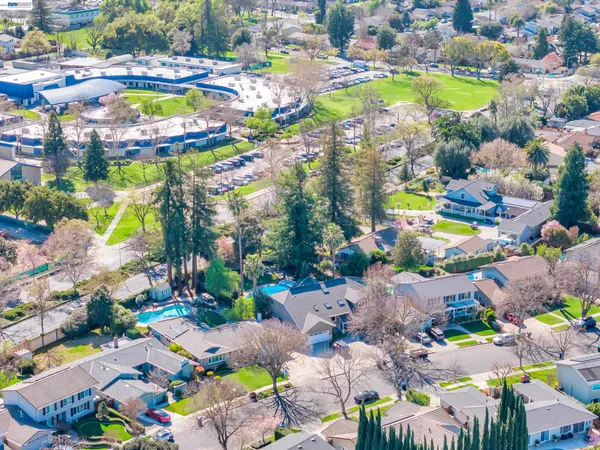 an aerial view of a houses with yard