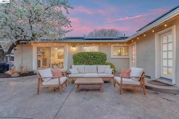 a swimming pool with outdoor seating and yard