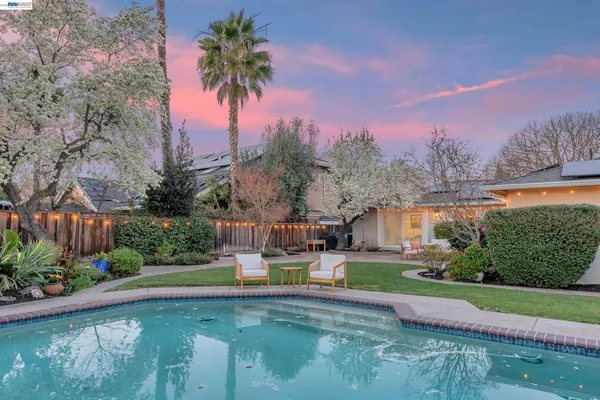 a view of a swimming pool and a yard