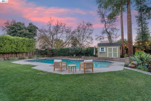 a view of a swimming pool with a yard