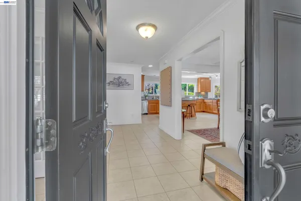 a view of a hallway with bathroom and glass door