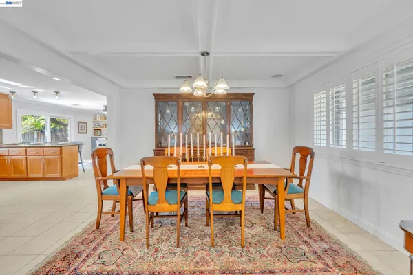 a view of a dining room with furniture and chandelier