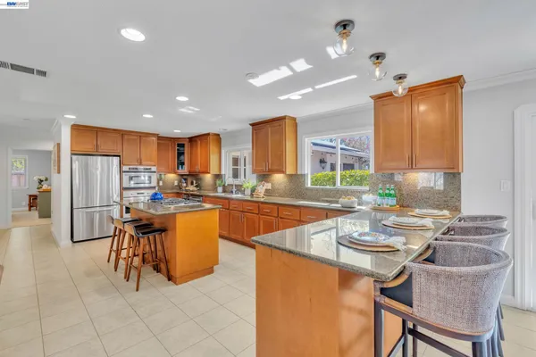 a dining room filled counter top space and stainless steel appliances with cabinets
