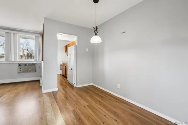 a view of wooden floor and chandelier in a room