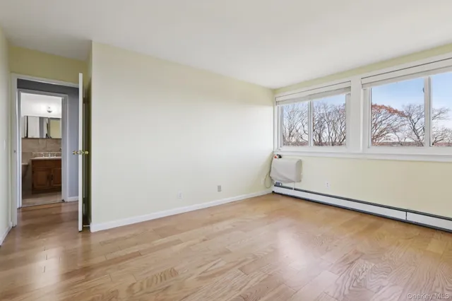 a white couch sitting next to a window