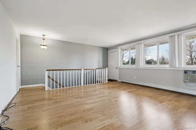 a view of a room with wooden floor