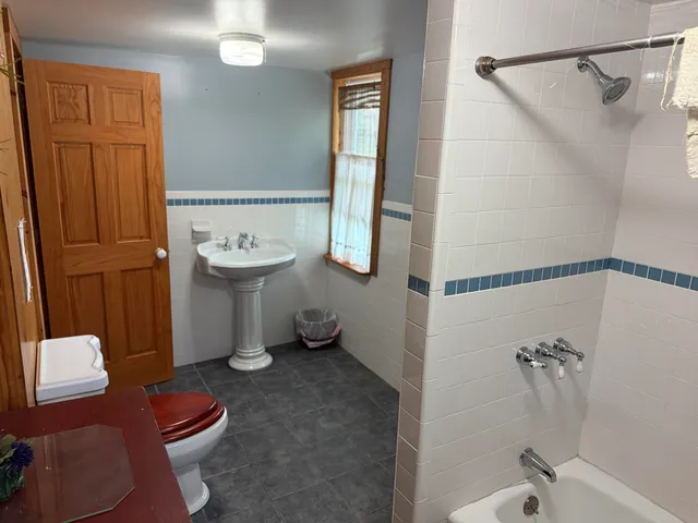 a bathroom with a sink toilet and shower