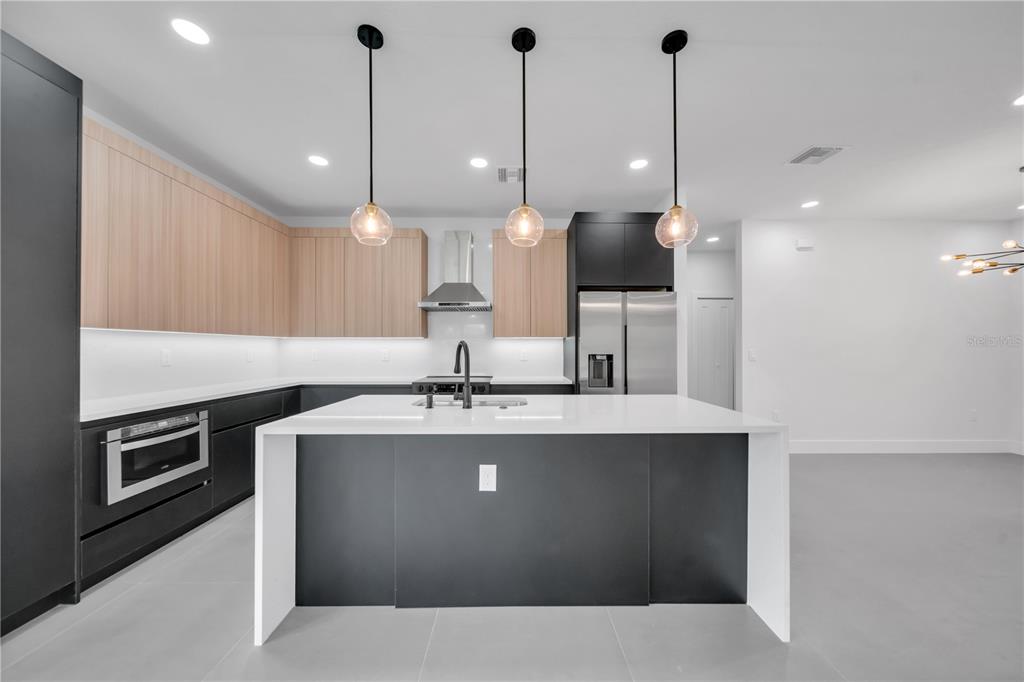 2328 Irondale Road North Port, FL 34287 - Photo 10 of 45 a kitchen with kitchen island a sink stainless steel appliances and chairs