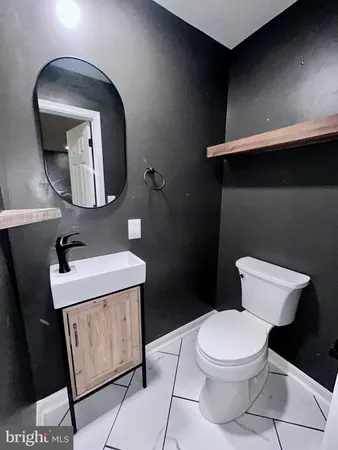 a view of kitchen island with sink and cabinets