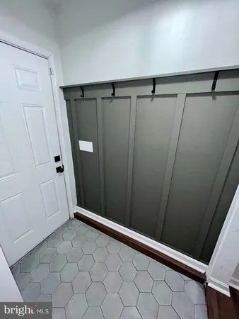 a view of a room with wooden floor and gym equipment