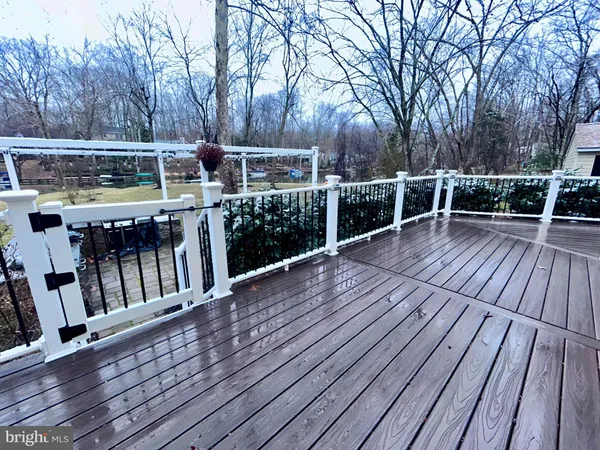 a view of a deck with table and chairs with wooden floor and fence