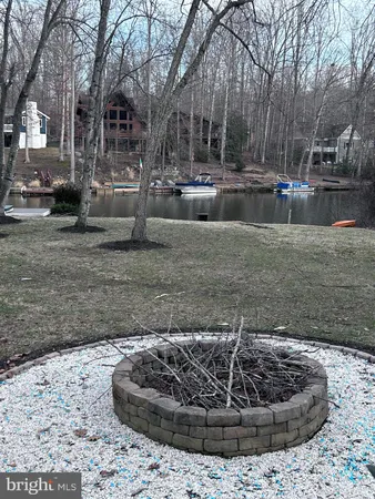 a view of house with a yard and potted plants