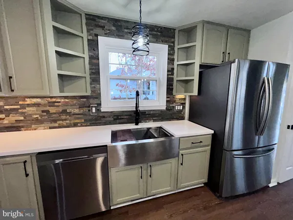 a kitchen with a refrigerator stove and sink