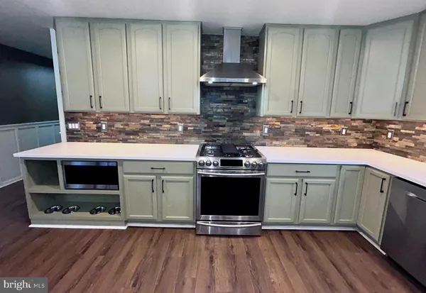 a kitchen with a stove and a microwave