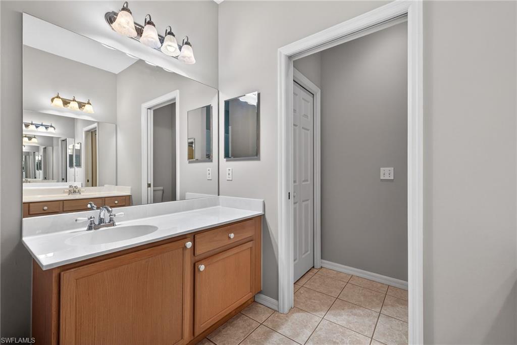 599 Crossfield Circle, Unit 35 Naples, FL 34104 - Photo 18 of 26 Bathroom with vanity and light tile patterned floors