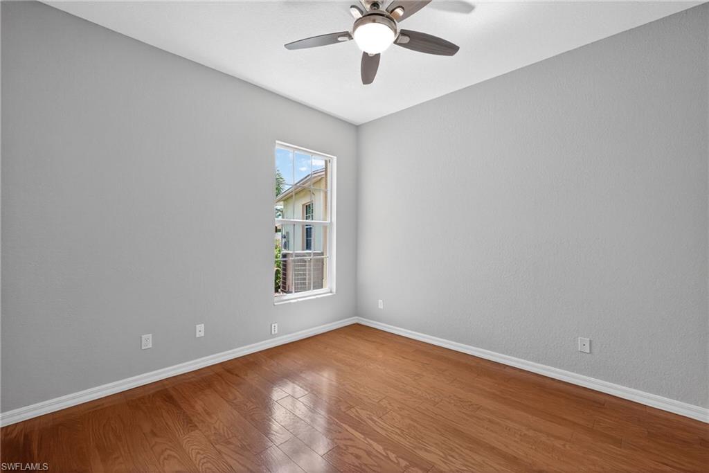 599 Crossfield Circle, Unit 35 Naples, FL 34104 - Photo 22 of 26 Spare room featuring wood-type flooring and a ceiling fan