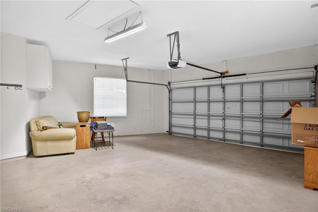 599 Crossfield Circle, Unit 35 Naples, FL 34104 - Photo 24 of 26 Garage with a garage door opener
