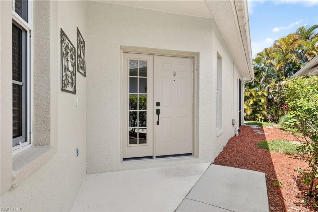 599 Crossfield Circle, Unit 35 Naples, FL 34104 - Photo 3 of 26 Property entrance featuring stucco siding