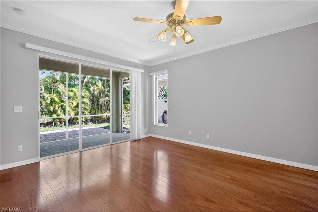 599 Crossfield Circle, Unit 35 Naples, FL 34104 - Photo 7 of 26 Empty room featuring crown molding, ceiling fan, and hardwood / wood-style flooring