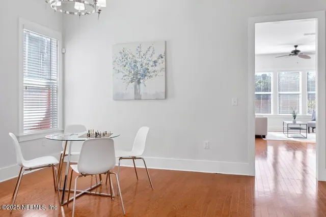 a view of a dining room with furniture and wooden floor