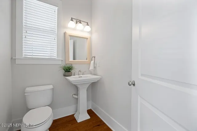 a bathroom with a sink toilet and a mirror