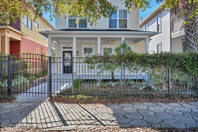 a view of a house with a small yard and plants