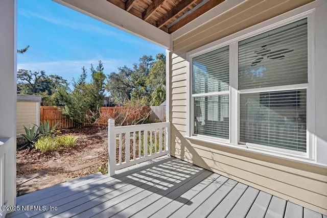 a view of a wooden deck with a yard