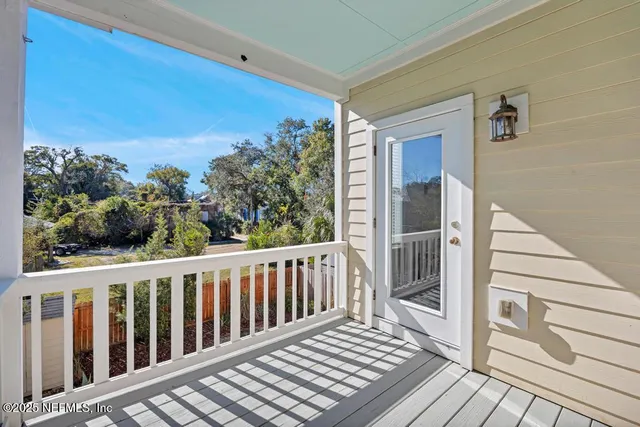 a view of a balcony with wooden floor