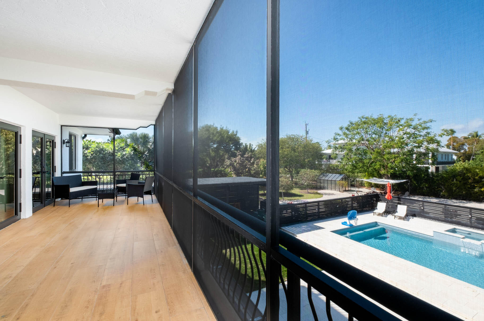 55 Ocean Front Drive Key Largo, FL 33037 - Photo 24 of 59 a view of a balcony with chairs and wooden floor