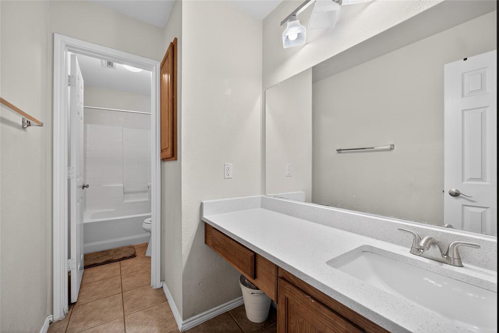9633 Anns Way Plano, TX 75025 - Photo 29 of 37 a bathroom with a sink and a mirror