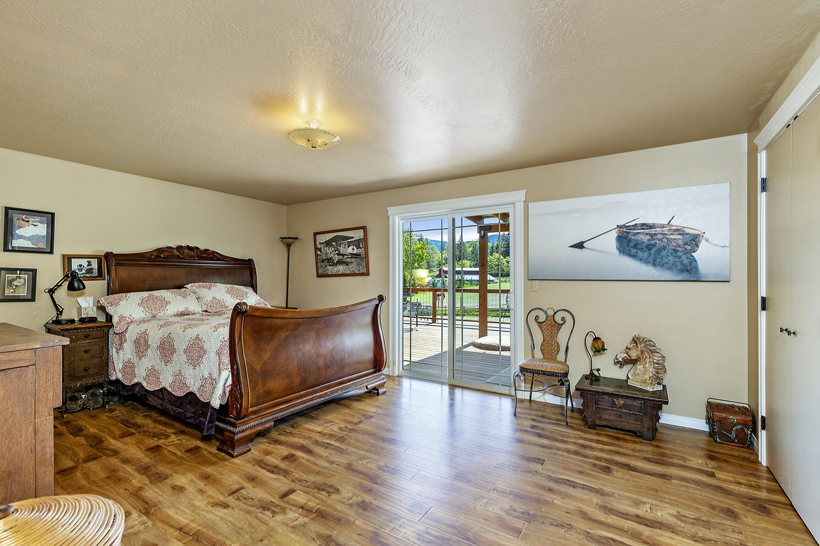 855 Holton Road Talent, OR 97540 - Photo 24 of 78 a bedroom with a bed and wooden floor