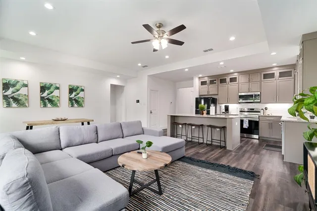 a living room with furniture and kitchen view
