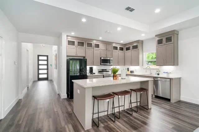 a large kitchen with a table and chairs in it