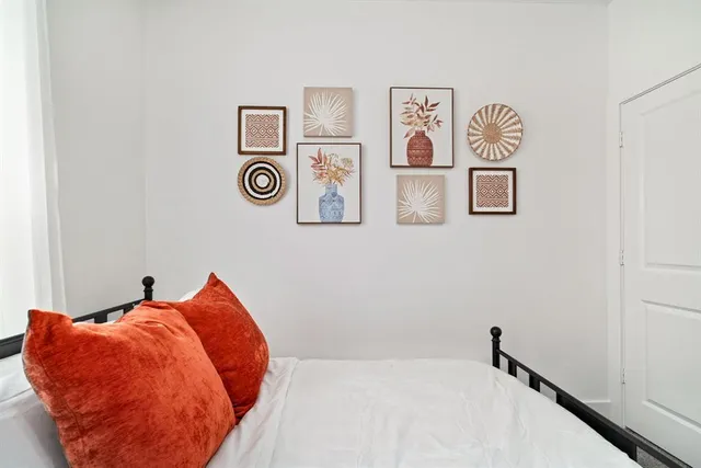 a bedroom with a bed and wall painting