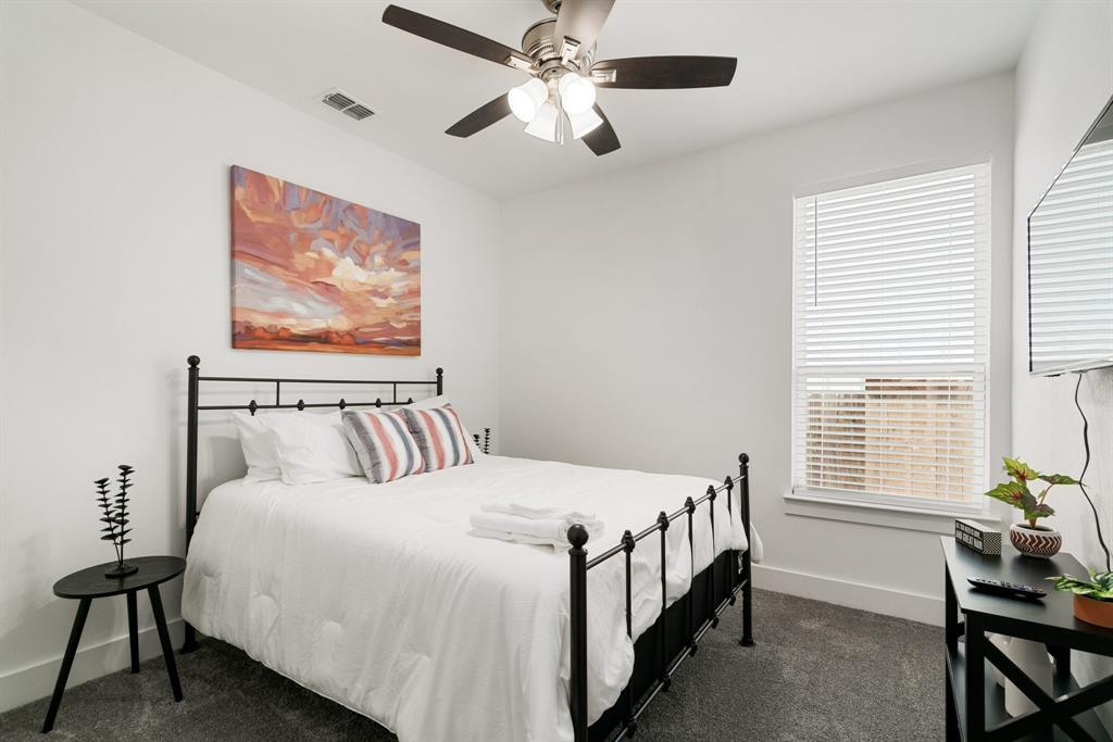 519 High Street Dallas, TX 75203 - Photo 33 of 38 a bed sitting in a bedroom next to a window